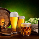 Beer barrel with beer glasses on a wooden table. The dark green background.